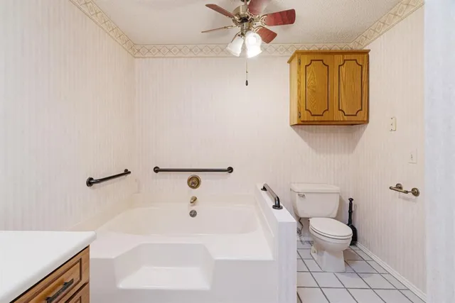 a bathroom with a sink a toilet and bathtub