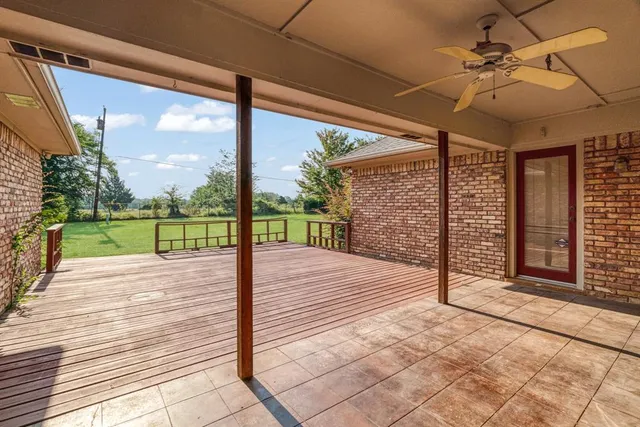 a view of a porch with wooden floor and fence