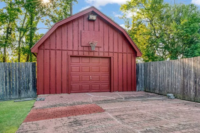 a view of barn with wooden fence