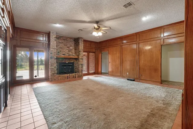 a view of an empty room with a fireplace