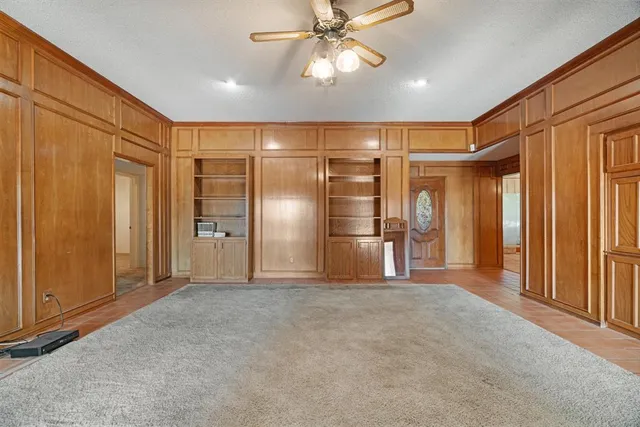a view of empty room with wooden walls