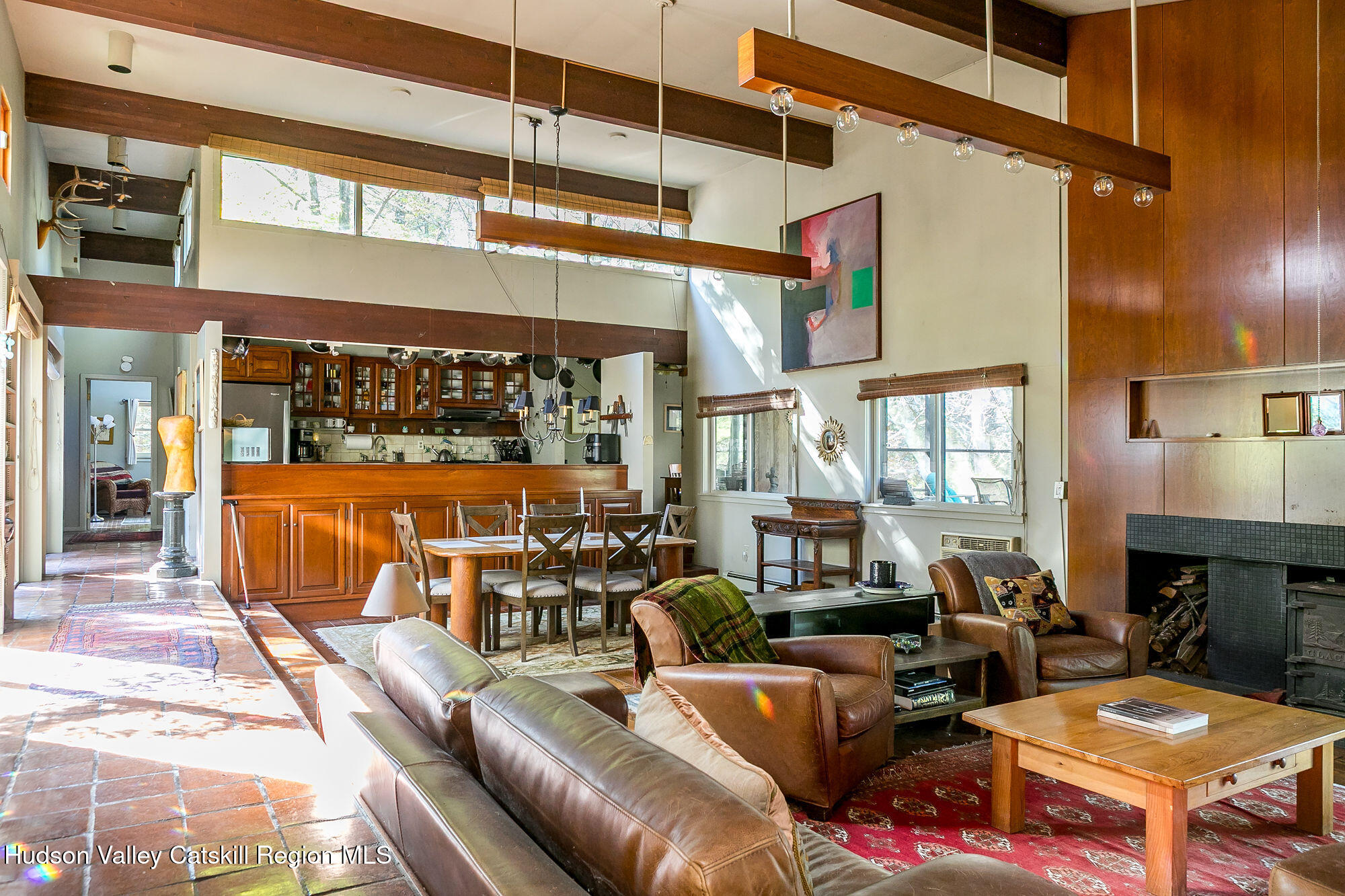 a living room with furniture a fireplace and a ceiling fan