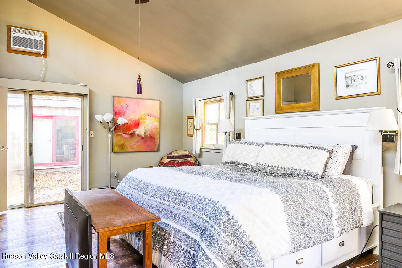 60 Phillips Road Saugerties, NY 12477 - Photo 7 of 23 a bedroom with a bed and glass wall