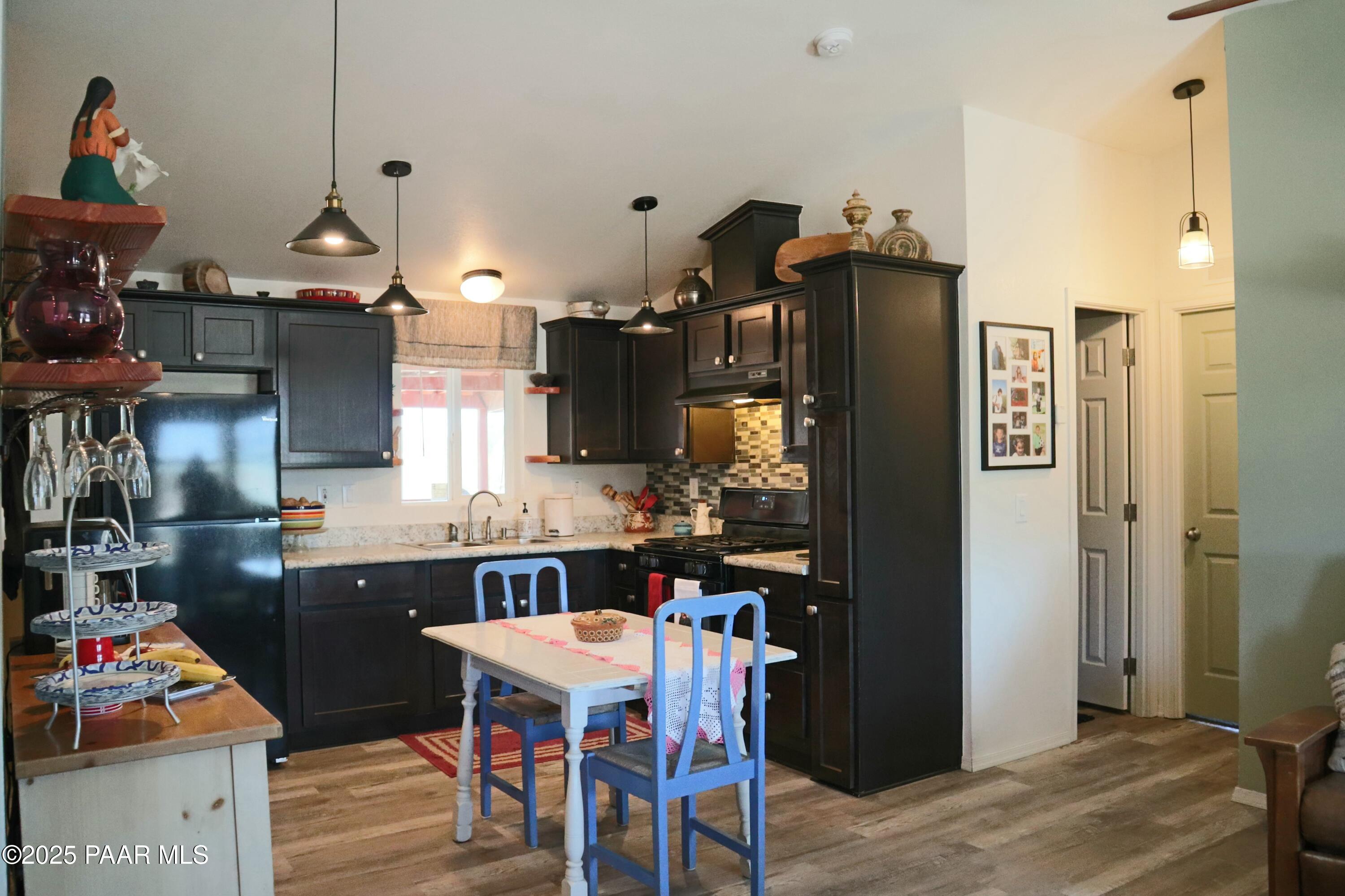 8850 West Fountain Ranch Road Ash Fork, AZ 86320 - Photo 5 of 29 a kitchen with stainless steel appliances granite countertop a refrigerator and a sink