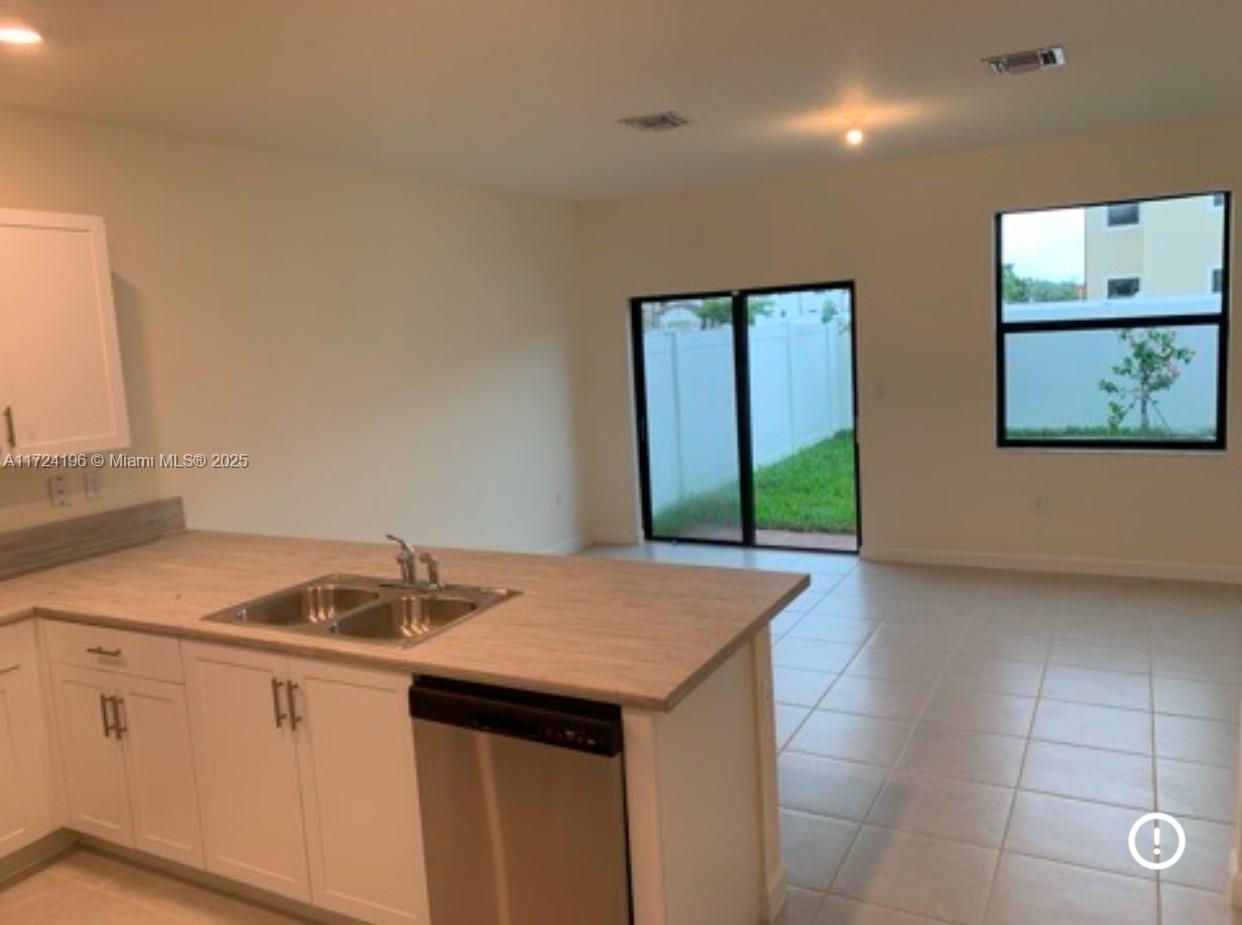 3416 West 111th Place Hialeah, FL 33018 - Photo 2 of 5 a kitchen with a sink and cabinets