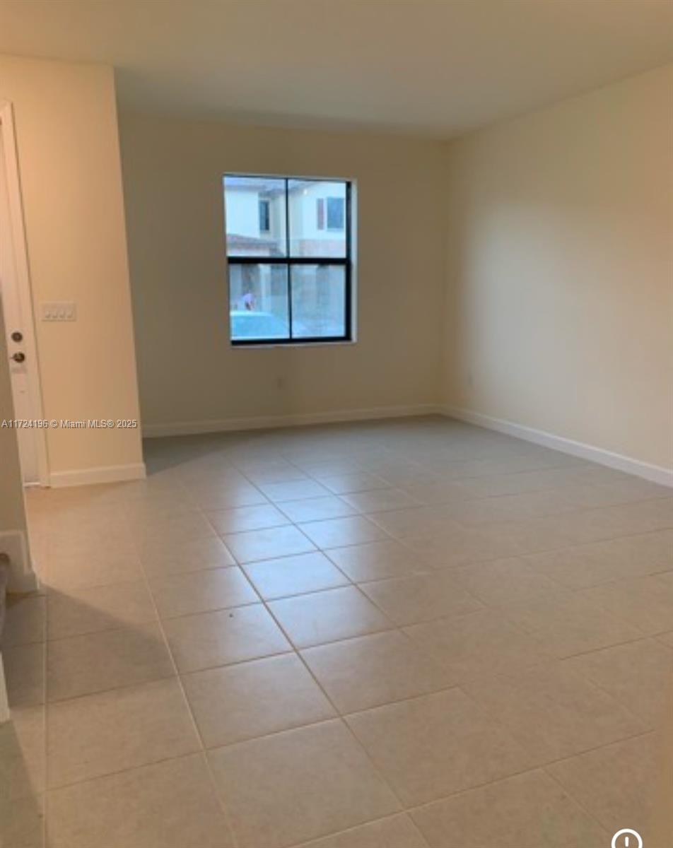 3416 West 111th Place Hialeah, FL 33018 - Photo 5 of 5 an empty room with windows and cabinet