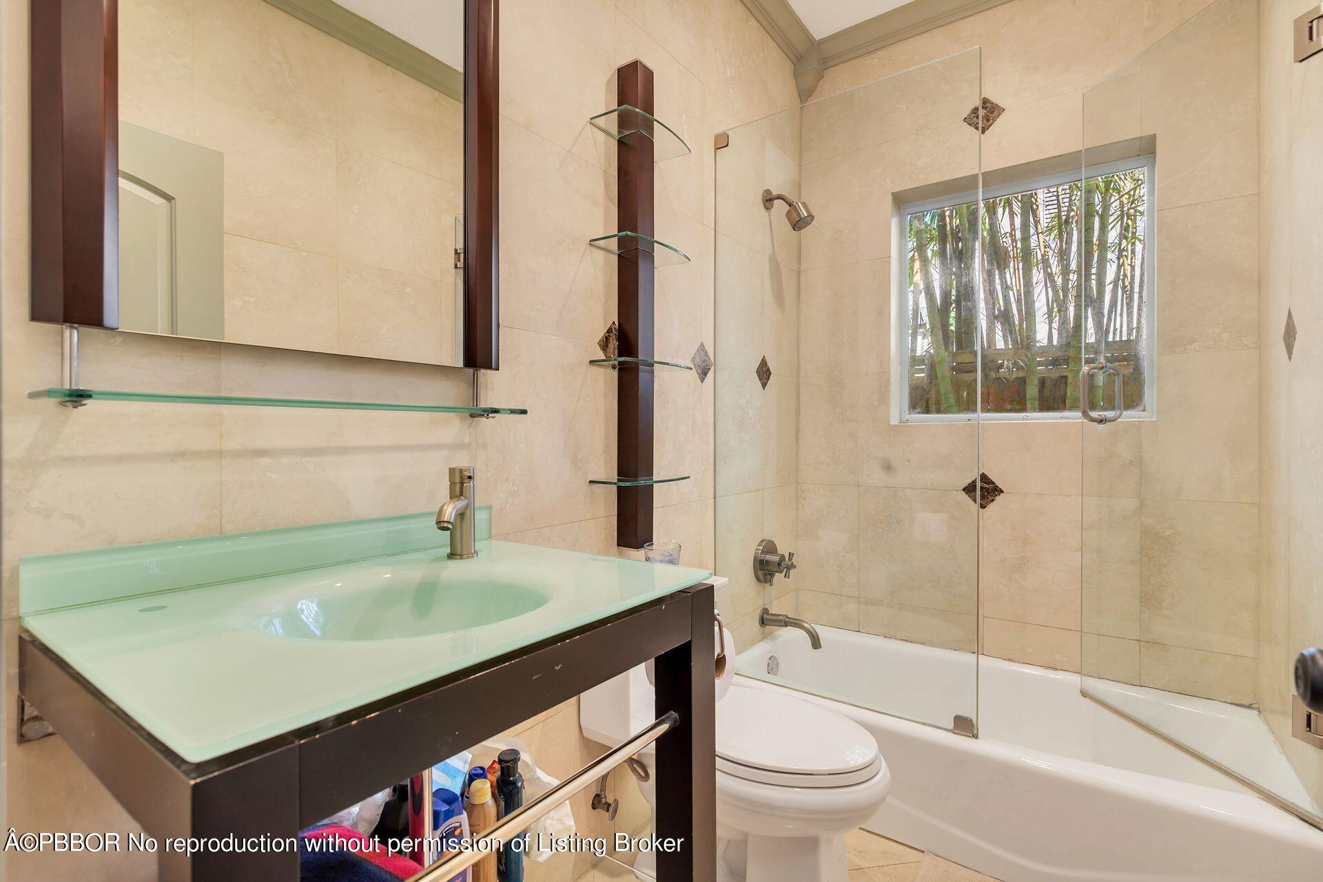 612 Upland Road West Palm Beach, FL 33401 - Photo 14 of 24 a bathroom with a sink a toilet and shower