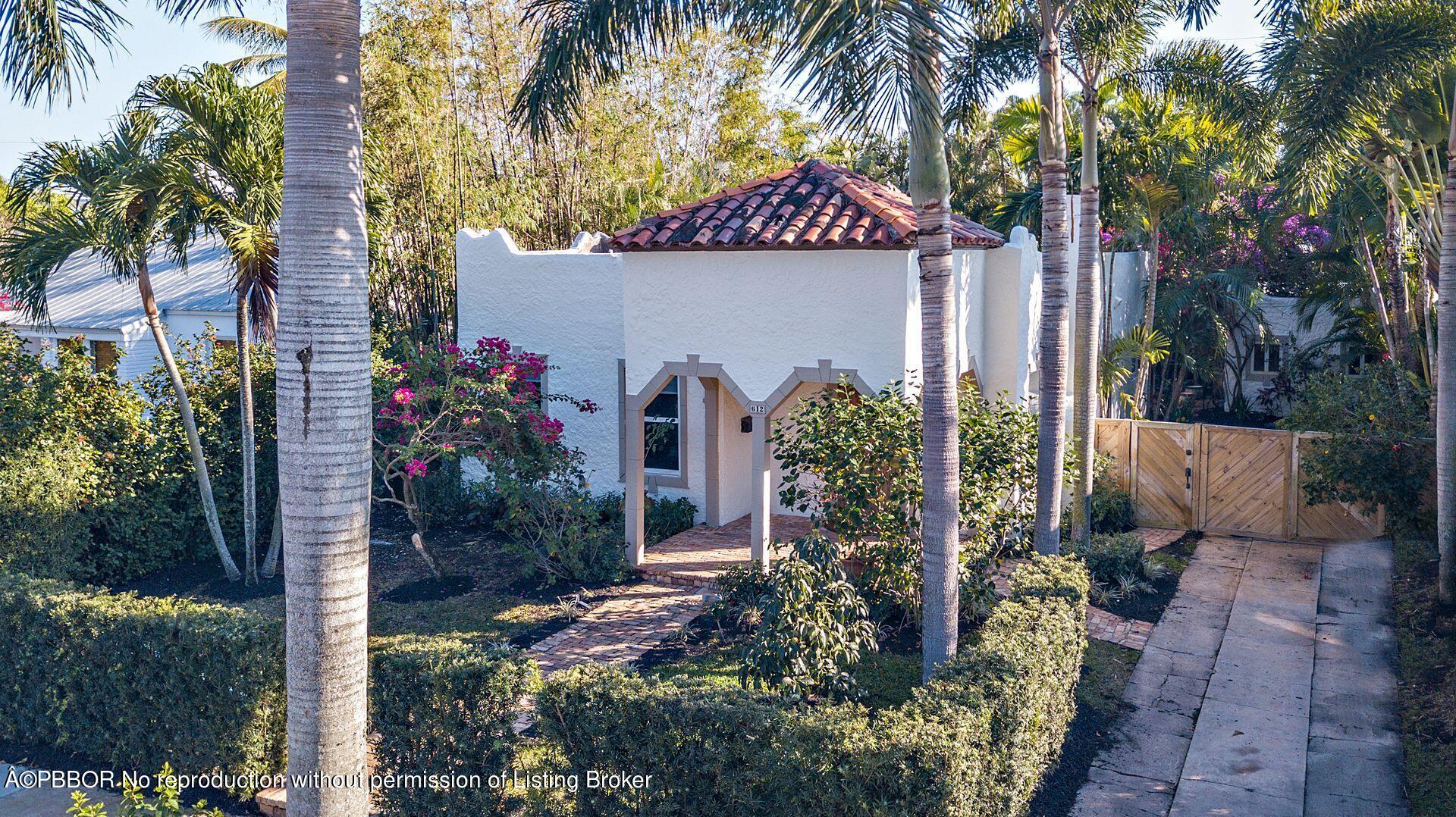 612 Upland Road West Palm Beach, FL 33401 - Photo 21 of 24 front view of a house with a garden