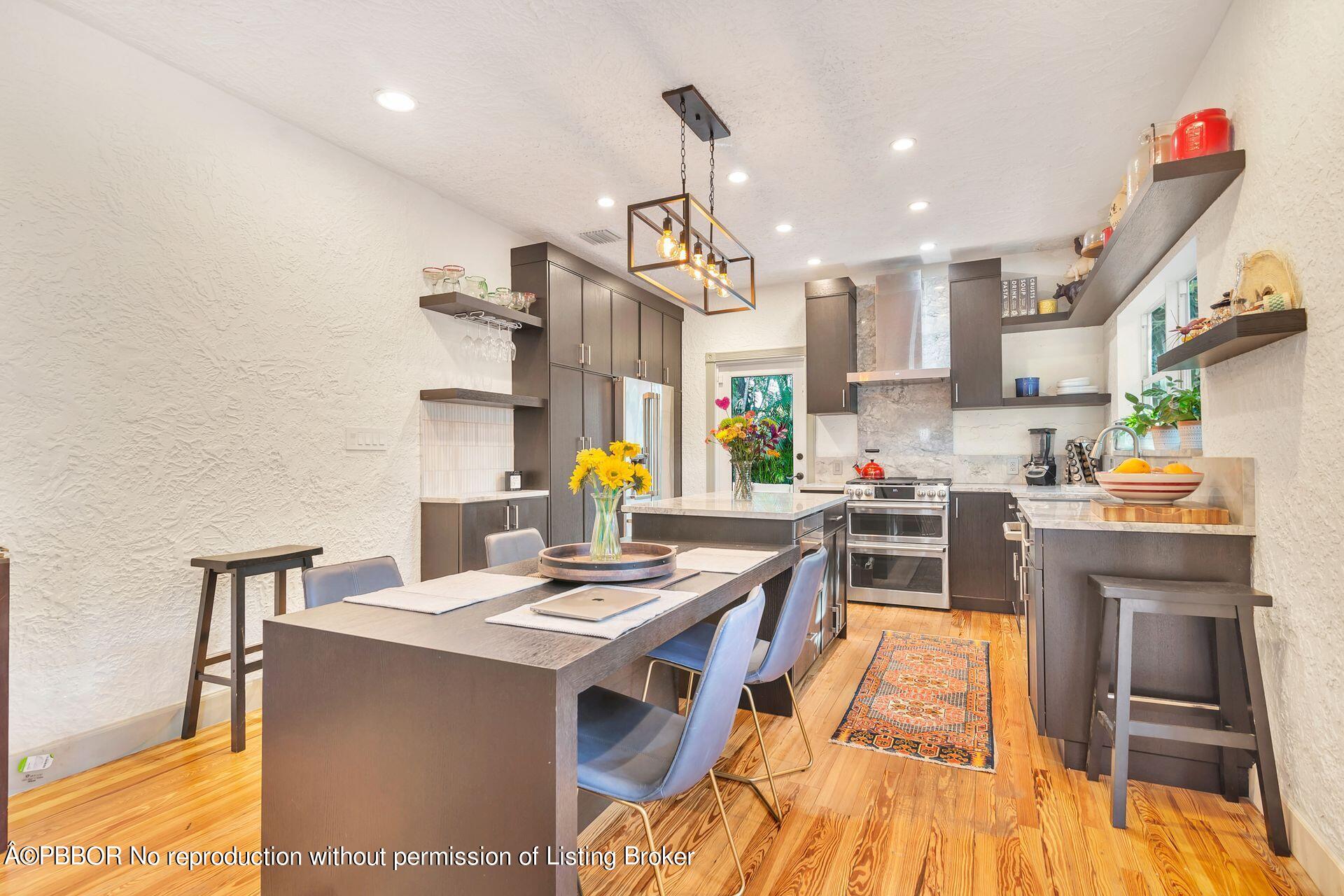 612 Upland Road West Palm Beach, FL 33401 - Photo 6 of 24 a kitchen with stainless steel appliances kitchen island granite countertop a sink and cabinets