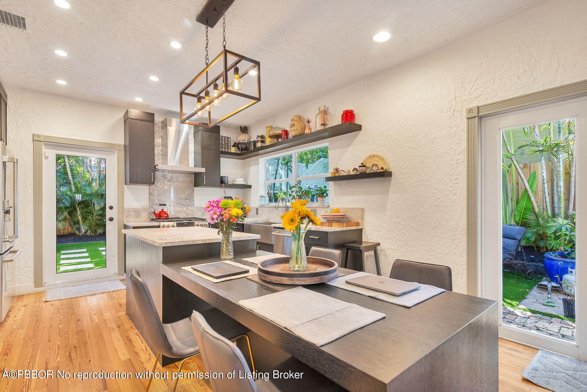 612 Upland Road West Palm Beach, FL 33401 - Photo 8 of 24 a kitchen with a table and chairs in it