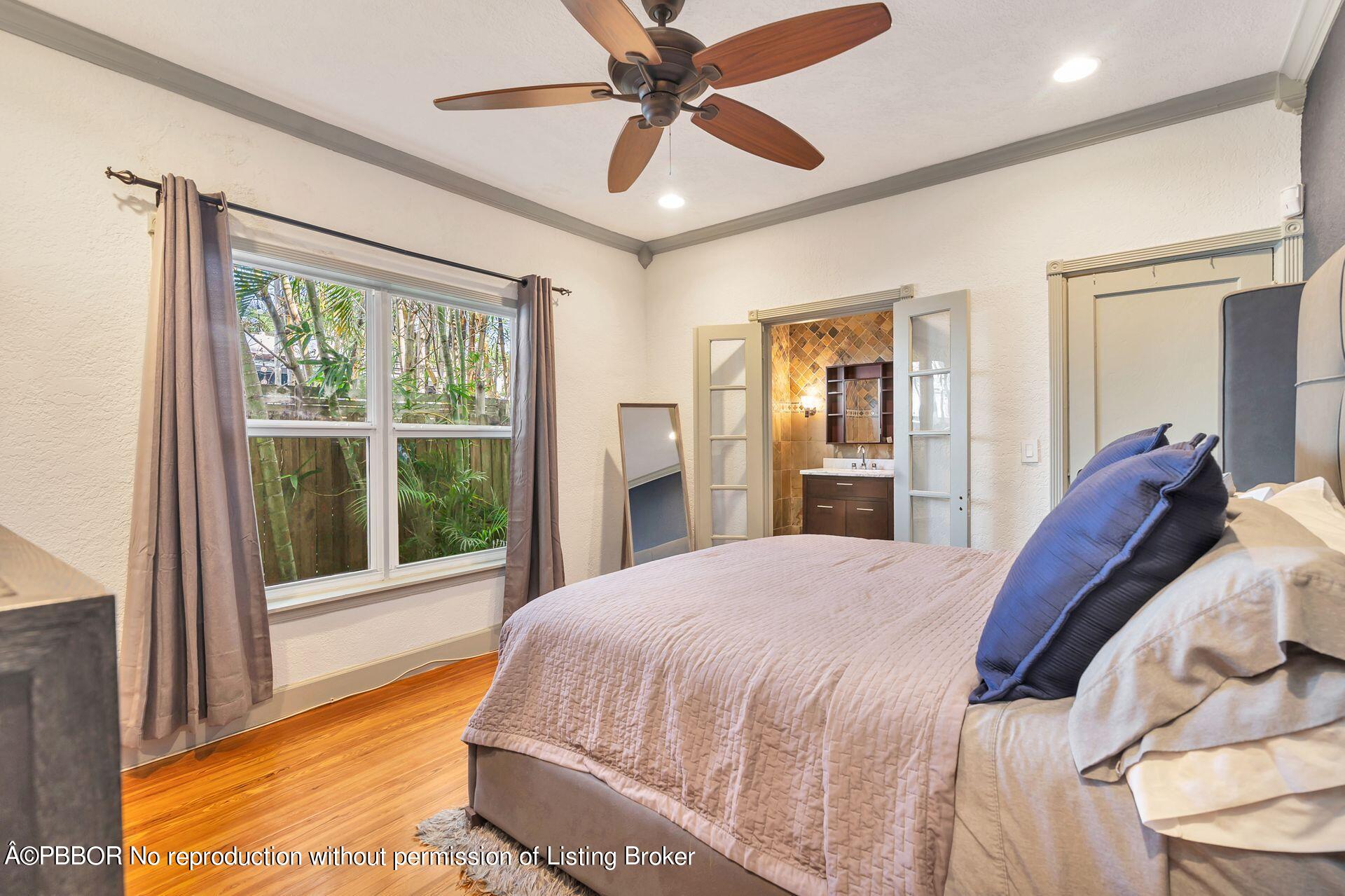 612 Upland Road West Palm Beach, FL 33401 - Photo 10 of 24 a bedroom with a bed and a large window