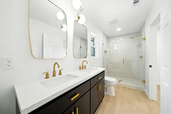 a bathroom with a double vanity sink mirror double and bathtub