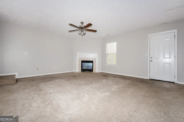 a view of empty room with a fireplace