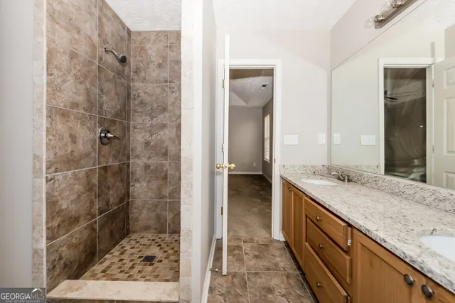 a bathroom with a granite countertop sink and a mirror