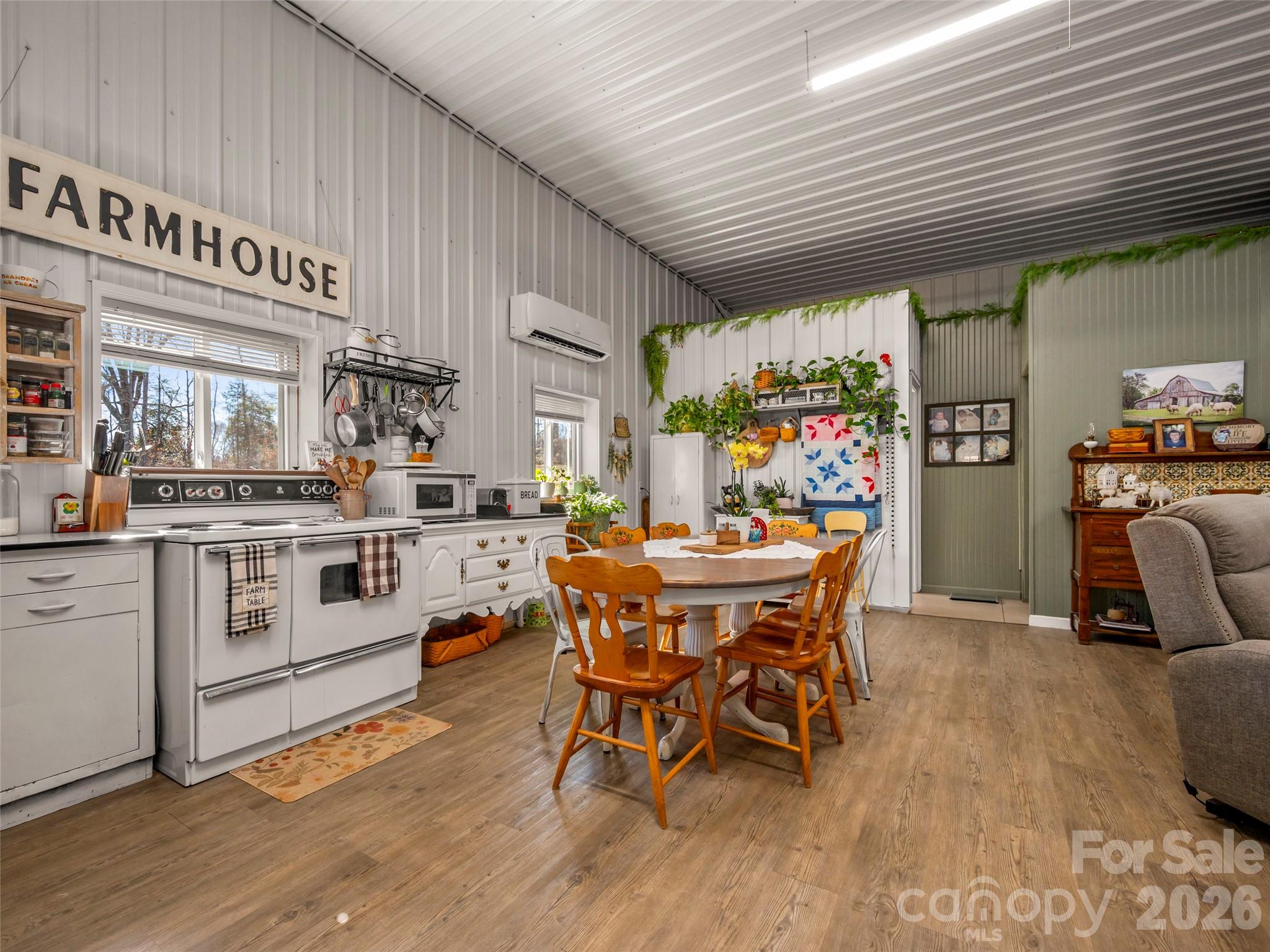 873 Ellenboro Henrietta Road Ellenboro, NC 28040 - Photo 11 of 48 a kitchen with stainless steel appliances kitchen island granite countertop a table chairs sink and cabinets