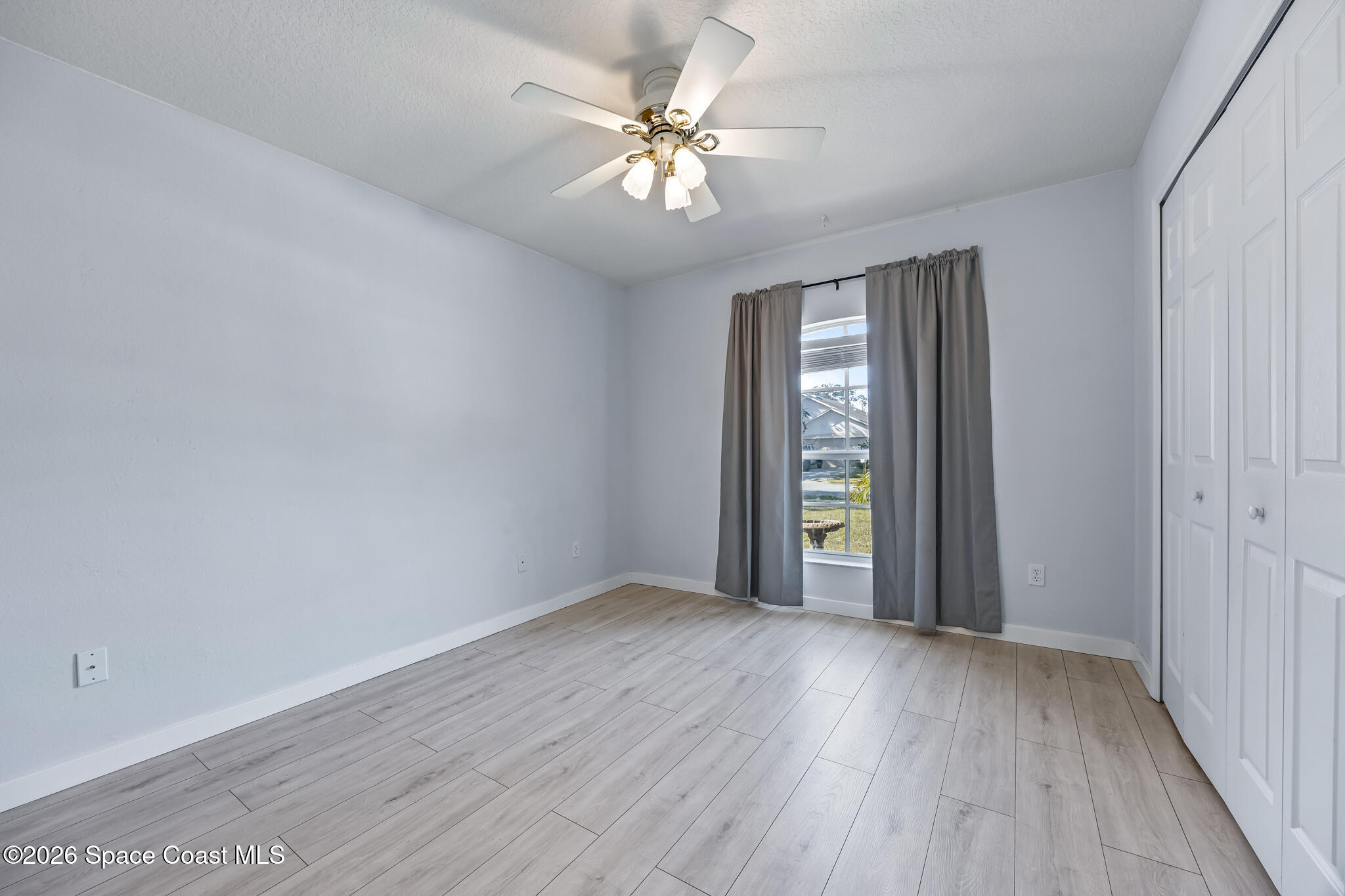 1915 Worchester Way Merritt Island, FL 32953 - Photo 15 of 27 a view of an empty room with window and wooden floor