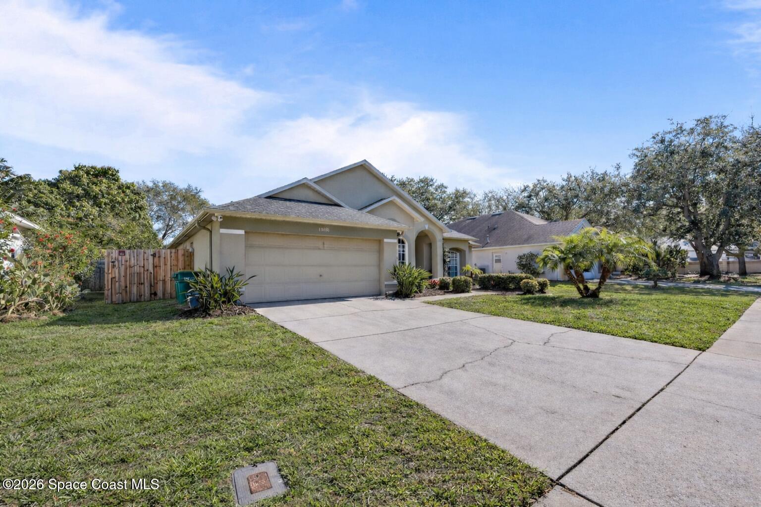 1915 Worchester Way Merritt Island, FL 32953 - Photo 27 of 27 a front view of a house with a yard and garage