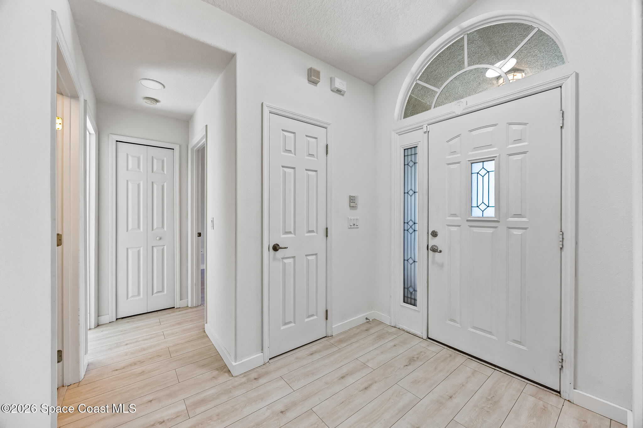 1915 Worchester Way Merritt Island, FL 32953 - Photo 3 of 27 an empty room with wooden floor and a mirror