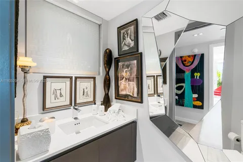 a bathroom with a sink a mirror and a bathtub