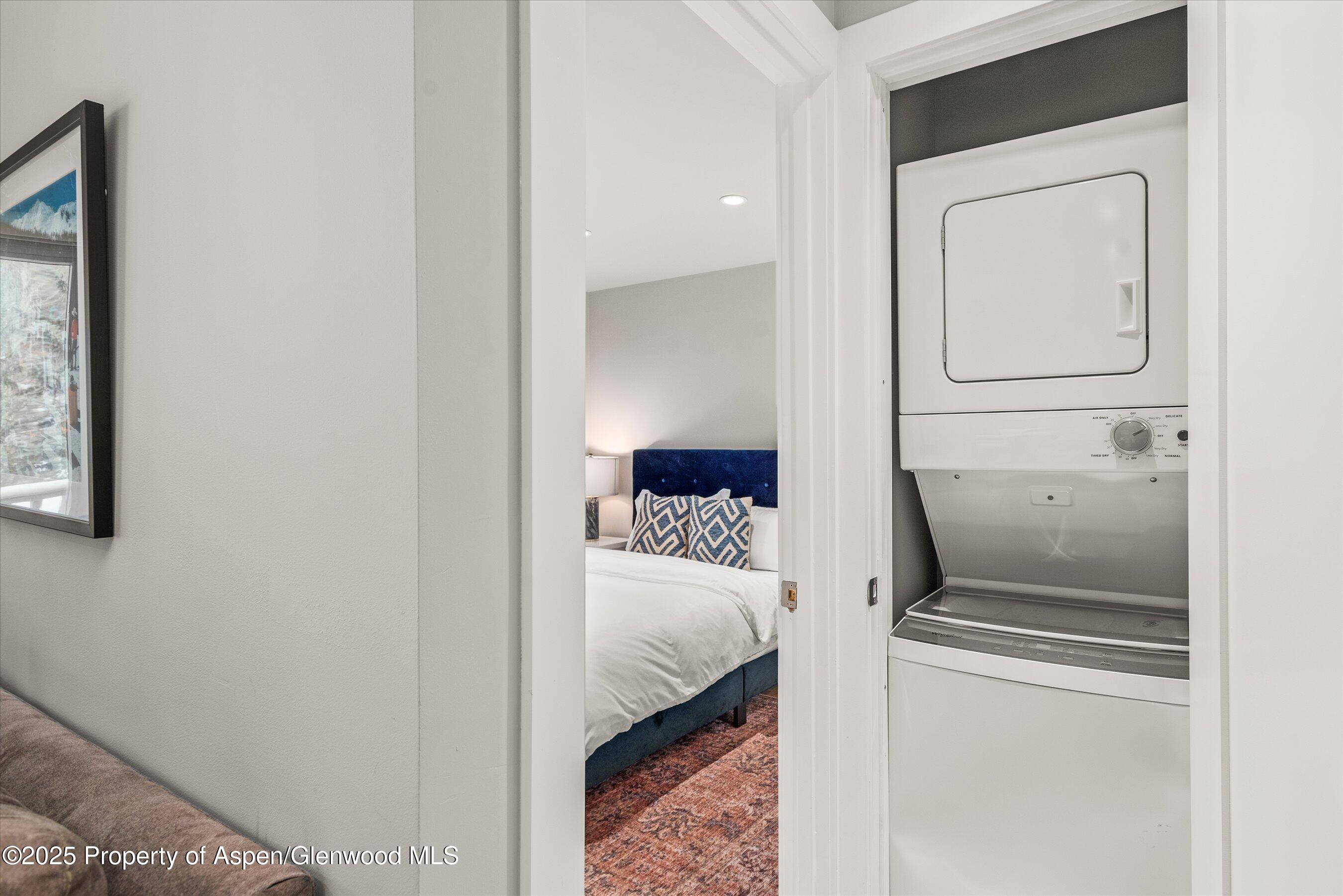 150 Carriage Way, Unit 3 Snowmass Village, CO 81615 - Photo 9 of 12 a bedroom with a bed and hallway