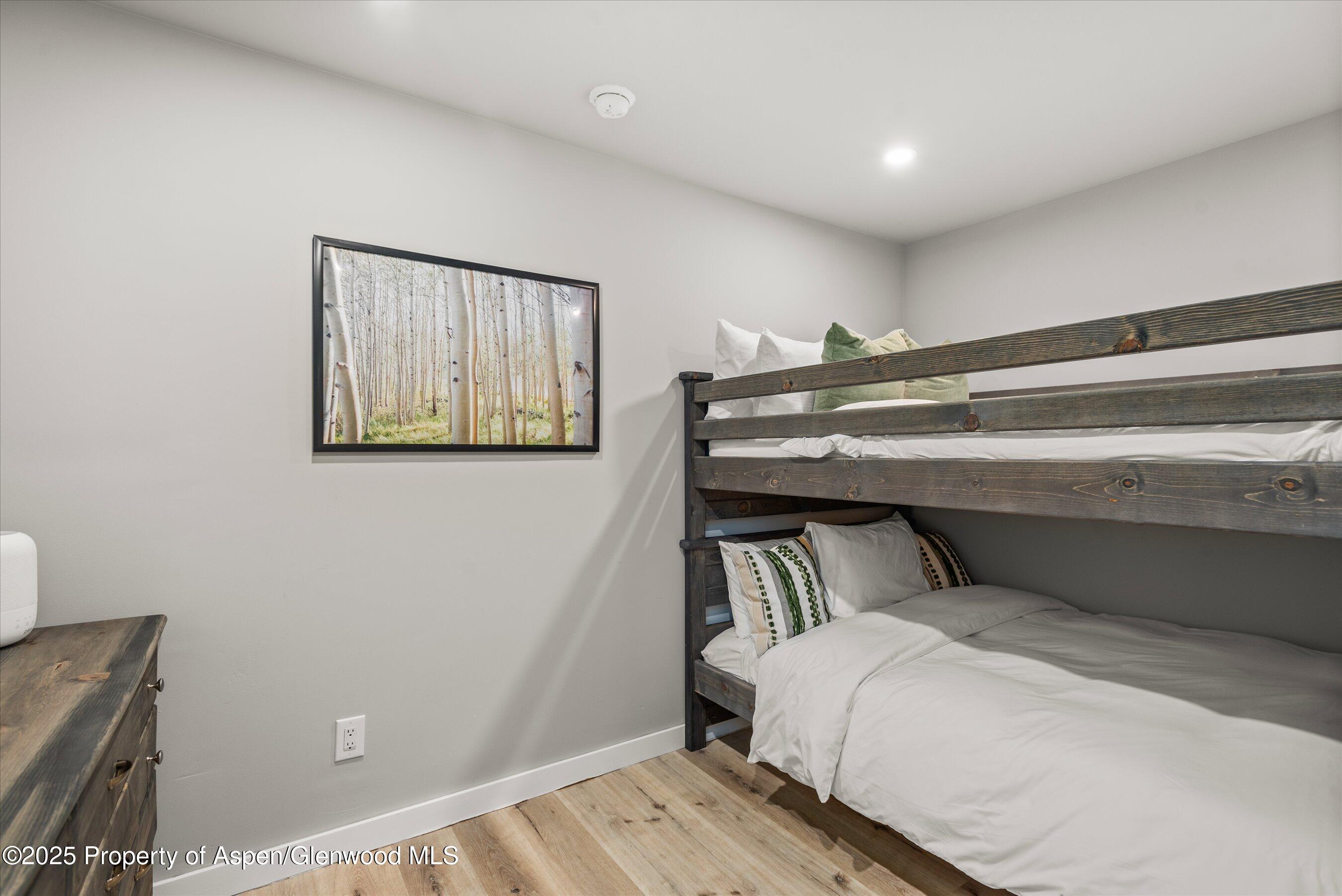 150 Carriage Way, Unit 3 Snowmass Village, CO 81615 - Photo 10 of 12 a bedroom with a bed and a window