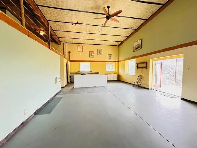 a living room with chairs and a table