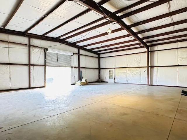a view of a dry yard with green space
