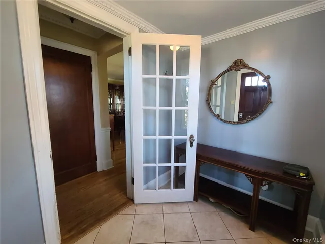 a view of a hallway with entryway and front door