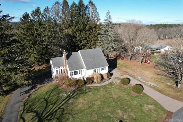 an aerial view of a house with yard and lake view