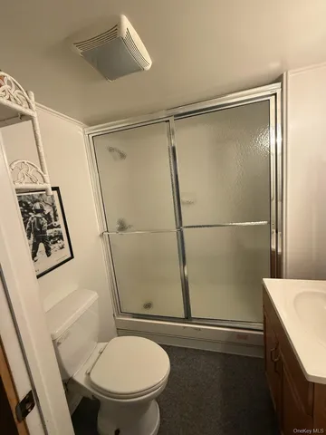 a bathroom with a toilet and a shower