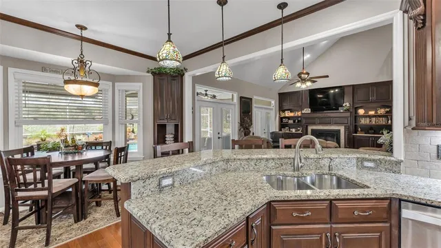 a view of a house with a yard and palm trees