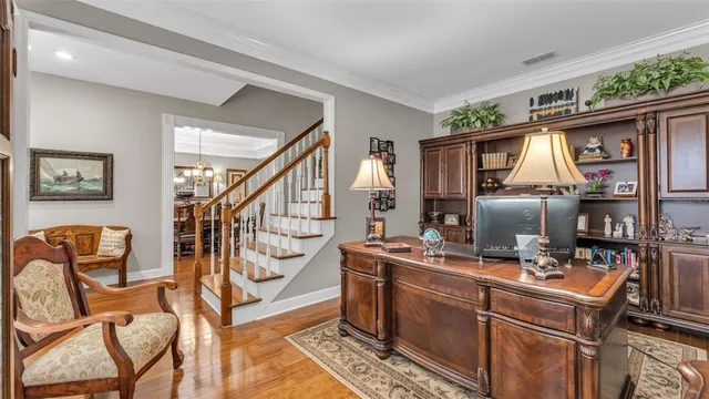 a view of a hallway with wooden floor and staircase