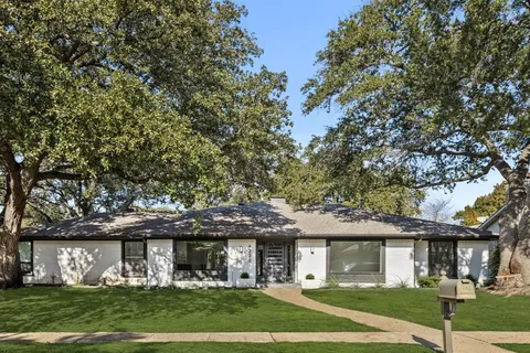 front view of a house with a tree