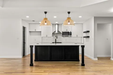a kitchen with stainless steel appliances granite countertop a sink and cabinets