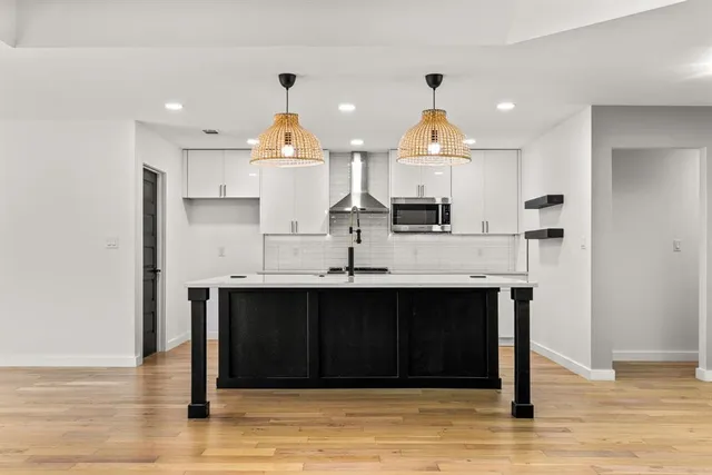 a kitchen with stainless steel appliances granite countertop a sink and cabinets