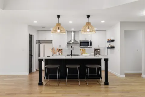 a kitchen with stainless steel appliances granite countertop a sink and cabinets