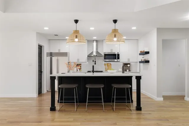a kitchen with stainless steel appliances granite countertop a sink and cabinets