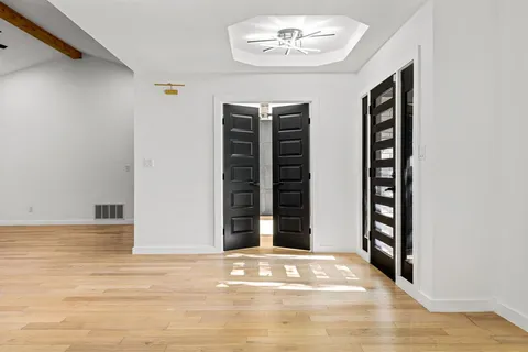 a view of an entryway with wooden floor