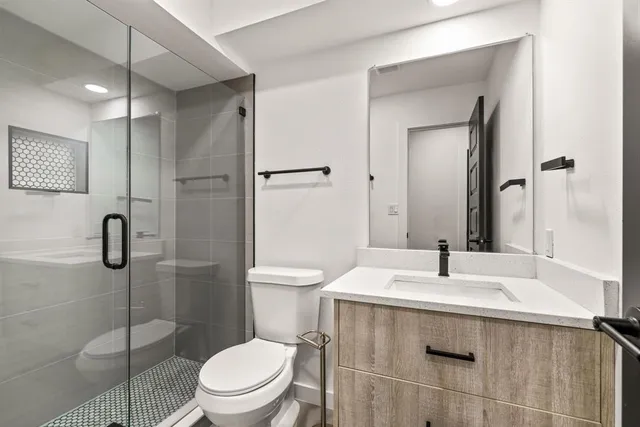 a bathroom with a sink toilet and shower