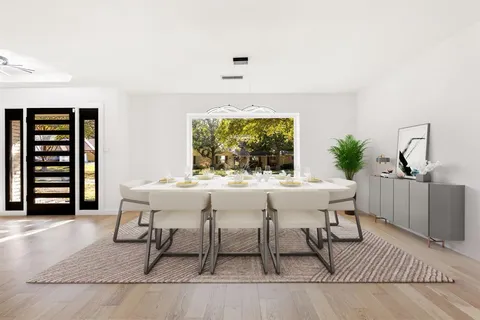 a dining room with furniture and window