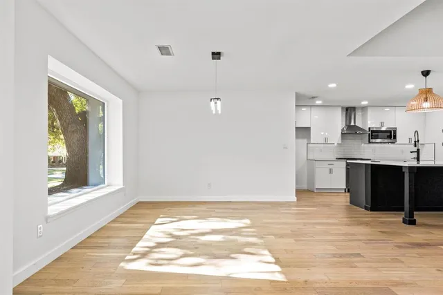 a view of kitchen with wooden floor and windows