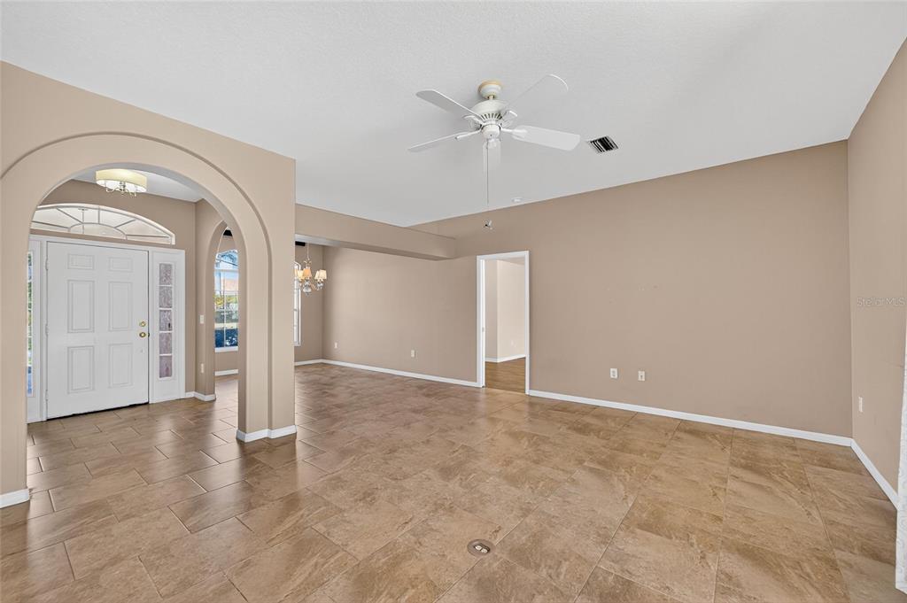 1615 Oracle Drive Ruskin, FL 33573 - Photo 18 of 87 an empty room with wooden floor and mirror