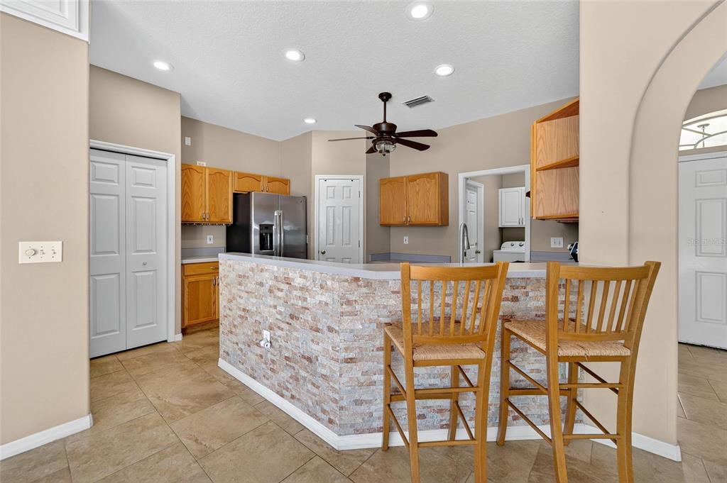 1615 Oracle Drive Ruskin, FL 33573 - Photo 24 of 87 a view of a kitchen with kitchen island granite countertop wooden floor cabinets and a counter top space