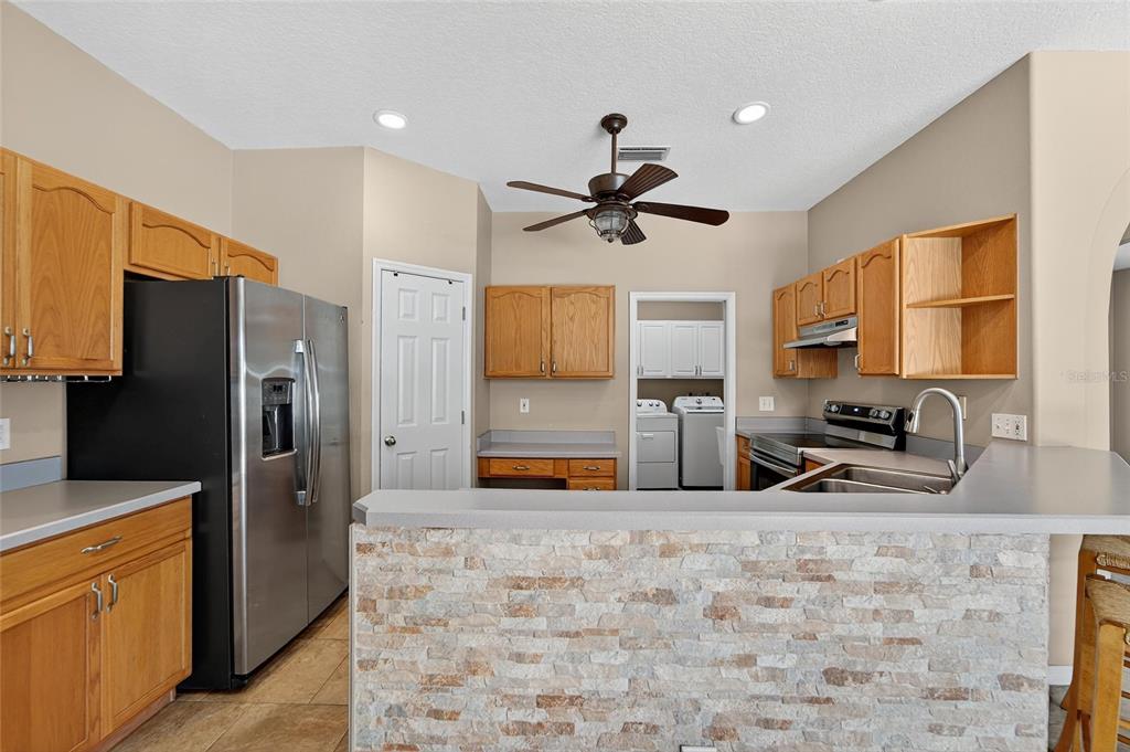 1615 Oracle Drive Ruskin, FL 33573 - Photo 25 of 87 a kitchen with stainless steel appliances a refrigerator sink and microwave