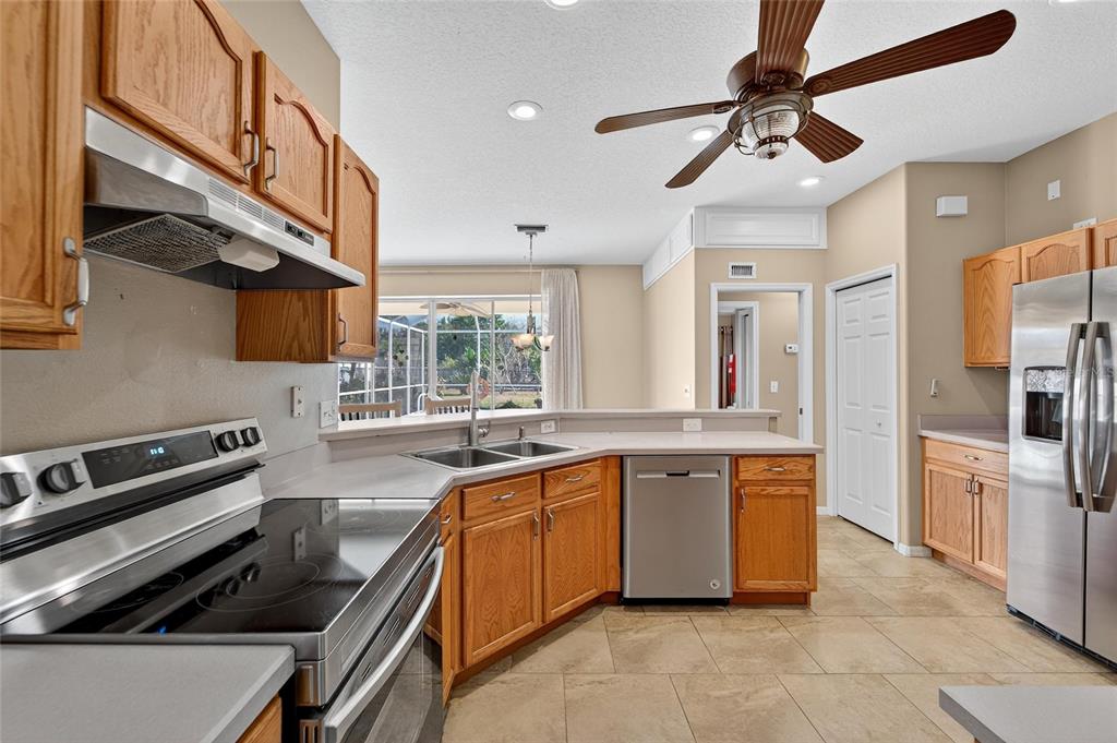 1615 Oracle Drive Ruskin, FL 33573 - Photo 27 of 87 outdoor kitchen with stainless steel appliances granite countertop a sink and a stove