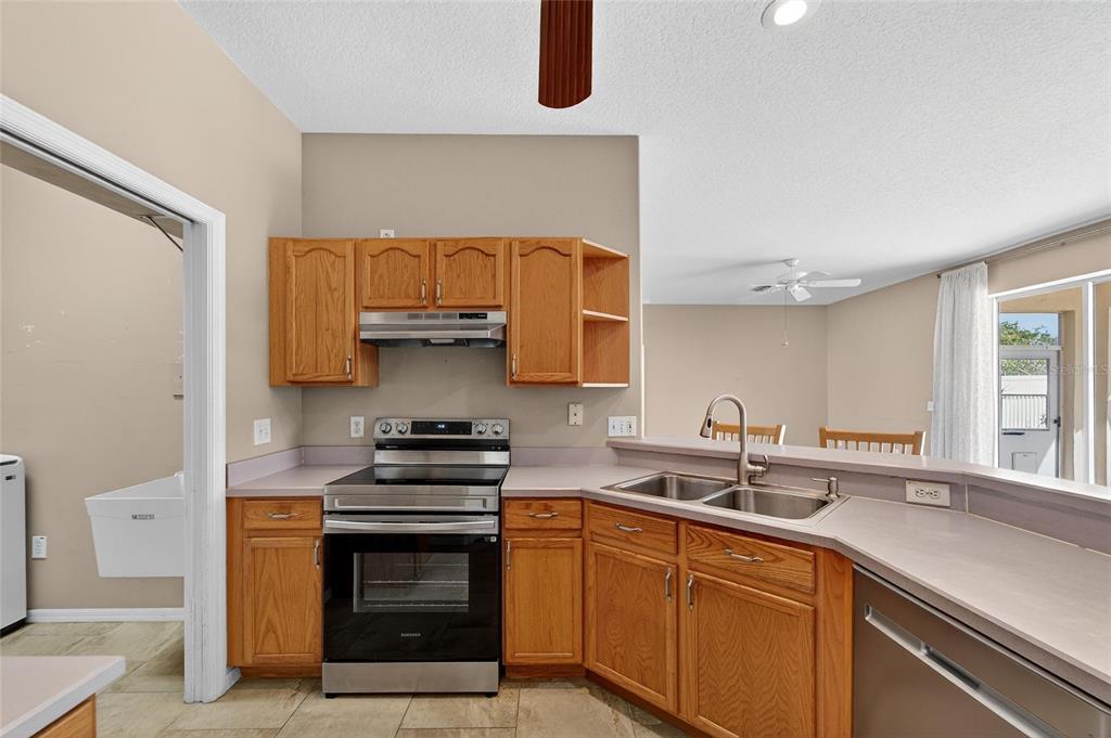 1615 Oracle Drive Ruskin, FL 33573 - Photo 28 of 87 a kitchen with a sink and a stove top oven