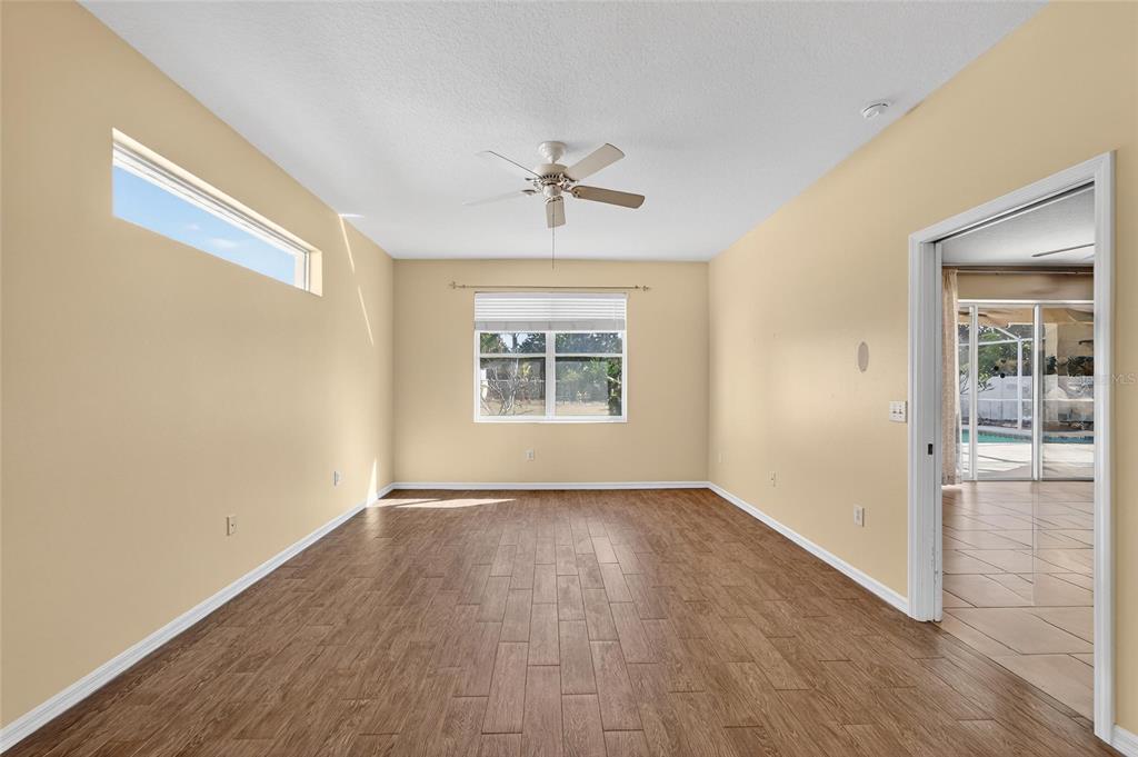 1615 Oracle Drive Ruskin, FL 33573 - Photo 36 of 87 wooden floor in an empty room with a window