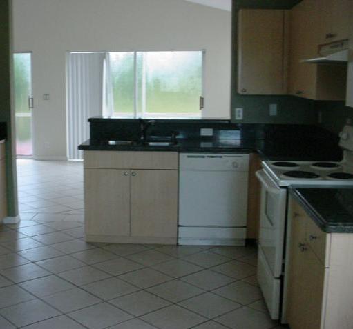11217 Harbour Springs Circle Boca Raton, FL 33428 - Photo 3 of 12 a kitchen with a sink and cabinets