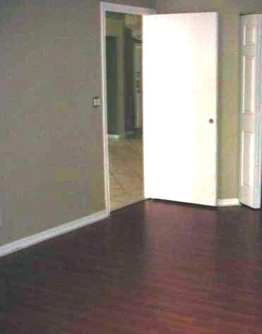 11217 Harbour Springs Circle Boca Raton, FL 33428 - Photo 6 of 12 an empty room with wooden floor and windows