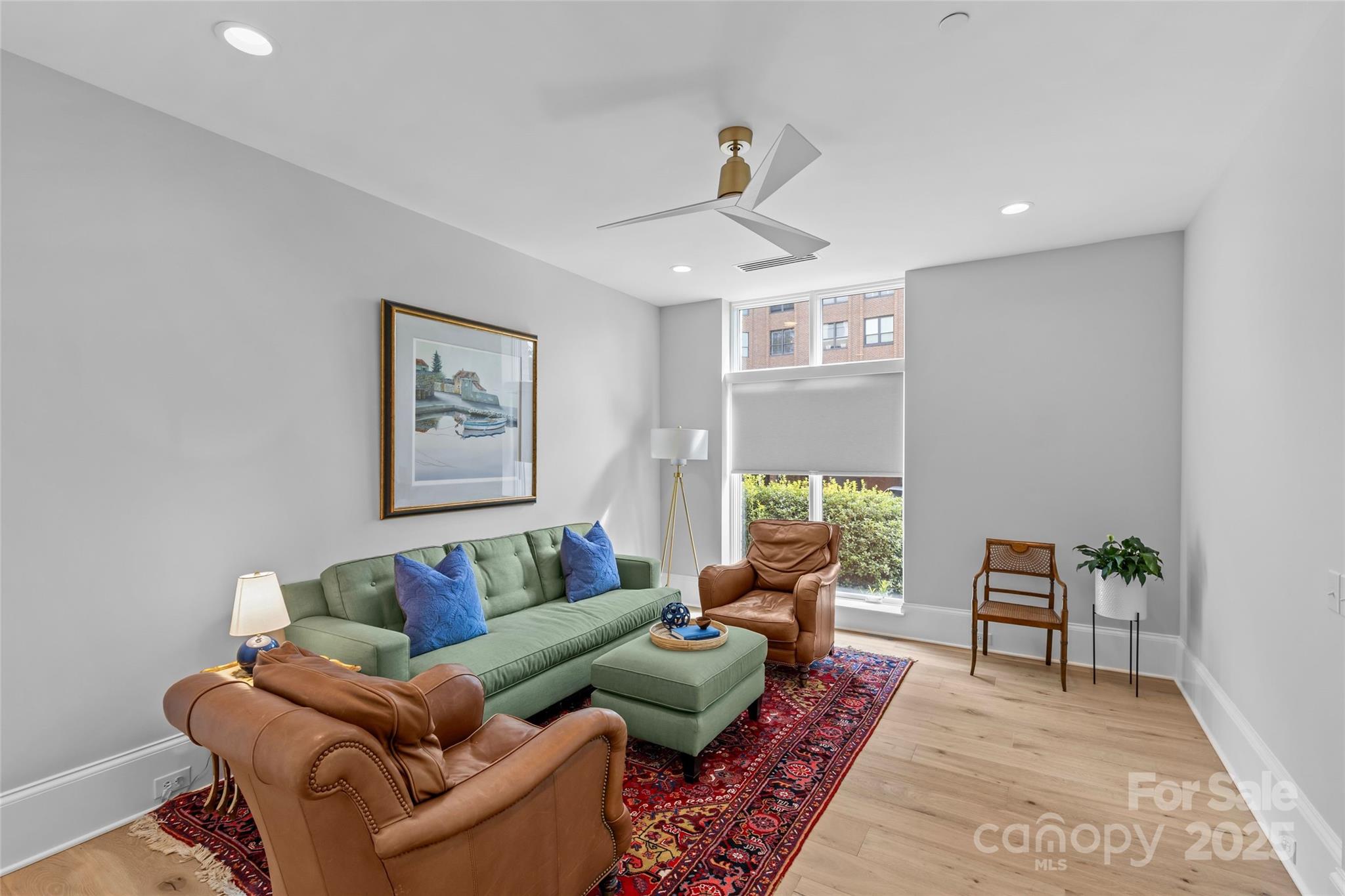 1500 Queens Road, Unit 104 Charlotte, NC 28207 - Photo 13 of 43 a living room with furniture and a rug